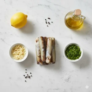 ngredientes para hacer navajas en freidora de aire: navajas frescas, ajo picado, perejil, aceite de oliva y limón dispuestos sobre una superficie clara.